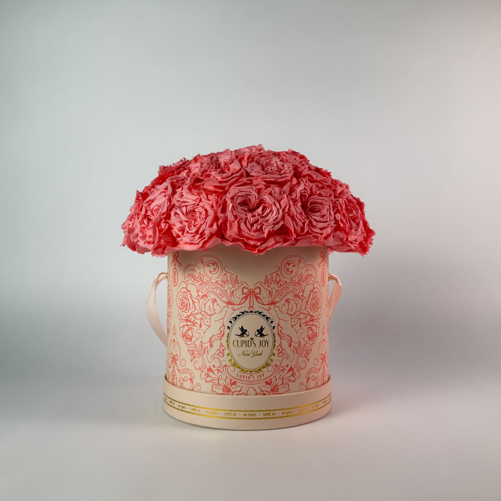 Decorative box with pink flowers on a light gray background